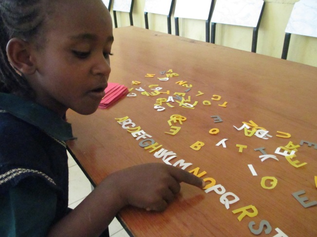 One of the orphans, learning her ABCs :)
